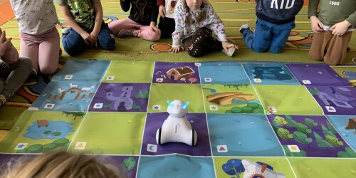 dzieci oglądające zaprogramowana trasę którą pokonuje robot
